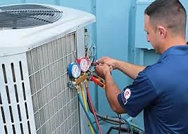 HVAC technician reading refrigerant gauges on an outdoor cooling system